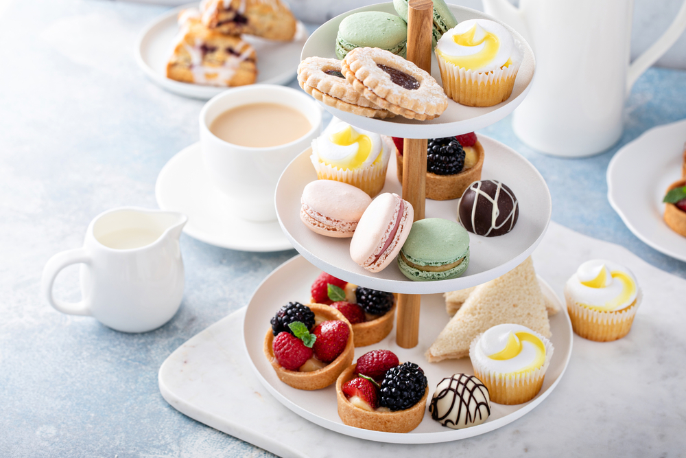 Spring or summer dessert table, three tiered tray with desserts High Tea in England